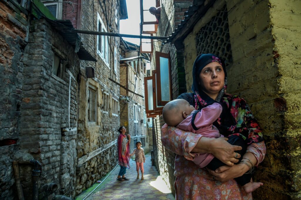 A woman with her nephew in Srinagar  on Aug. 8. Photo by Atul Loke for NY Times