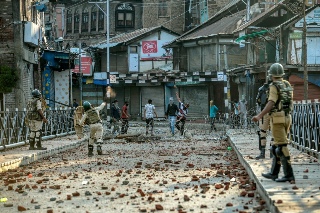 Protesters throwing stones in Srinagar  on Aug. 8. Photo by Atul Loke for NY Times