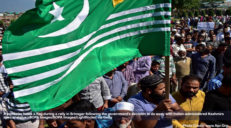 A protester holds a flag during a rally in Srinagar following the government's decision to do away with Indian-administered Kashmir's special status