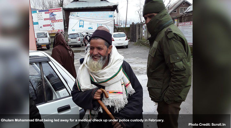 Ghulam Mohammad Bhat being led away for a medical check up under police custody in February.