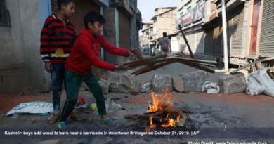 Kashmiri boys add wood to burn near a barricade in downtown Srinagar on October 31, 2019.