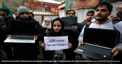 Kashmiri journalists hold placards and laptops in Srinagar last month to protest the Internet shutdown