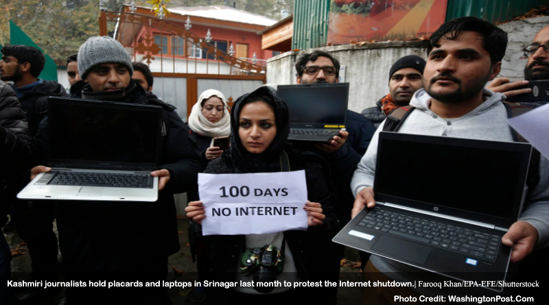 Kashmiri journalists hold placards and laptops in Srinagar last month to protest the Internet shutdown