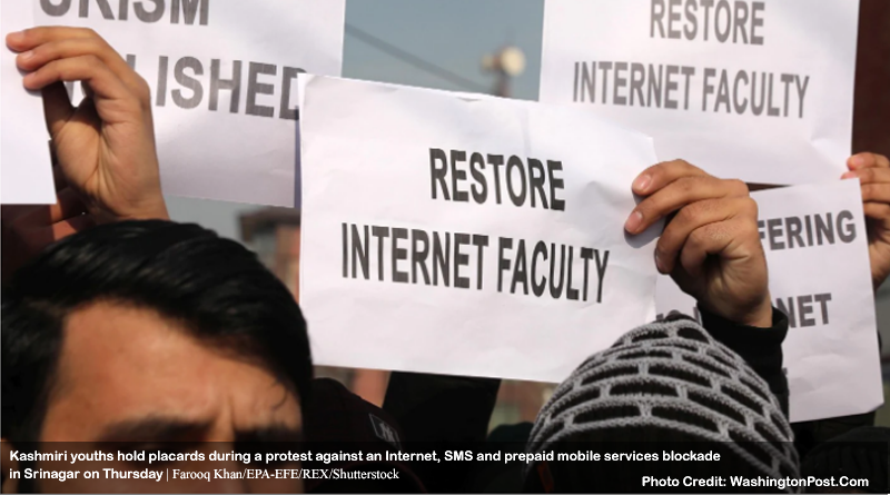 Kashmiri youths hold placards during a protest against an Internet, SMS and prepaid mobile services blockade in Srinagar on Thursday.